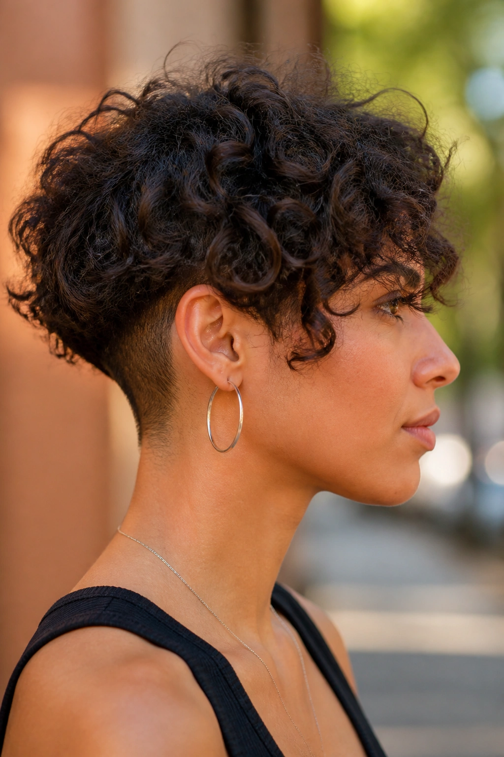 Close-up of a person with an undercut in a curly bob hairstyle