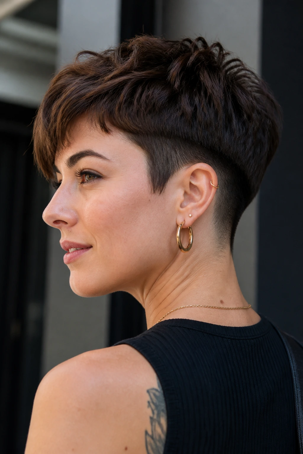 Portrait of a woman with an undercut pixie and visible nape undercut.