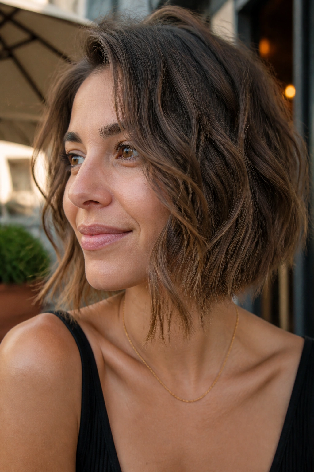 Close-up of a real woman with a wavy undone angled bob in natural light