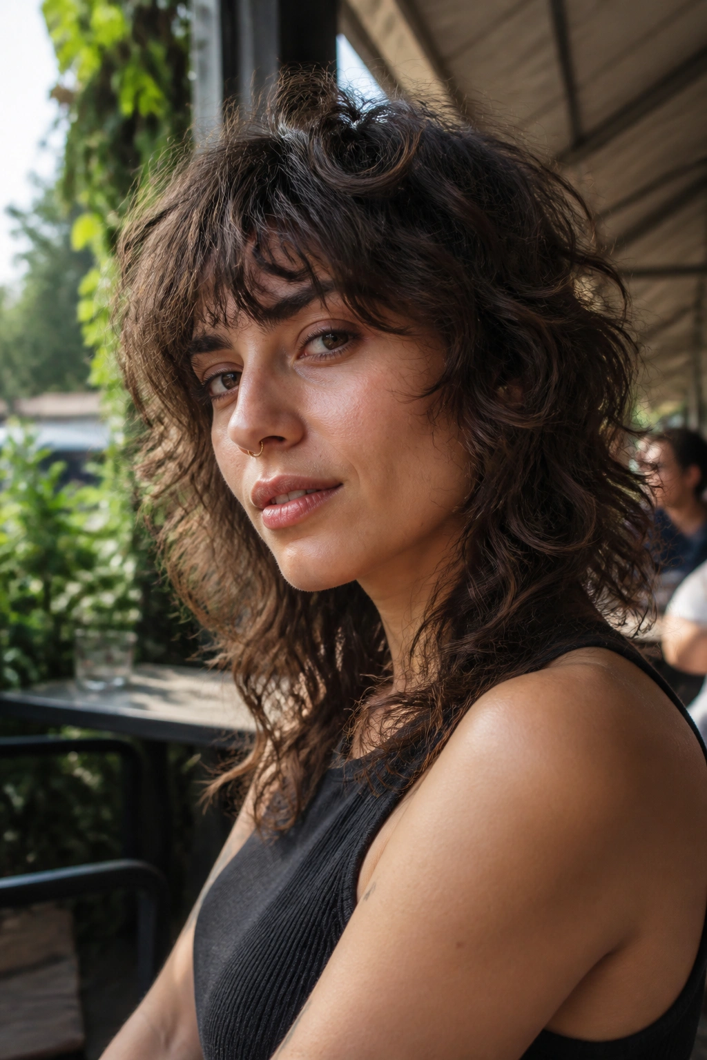 Close-up portrait of a real person with a wavy wolf cut in an outdoor setting