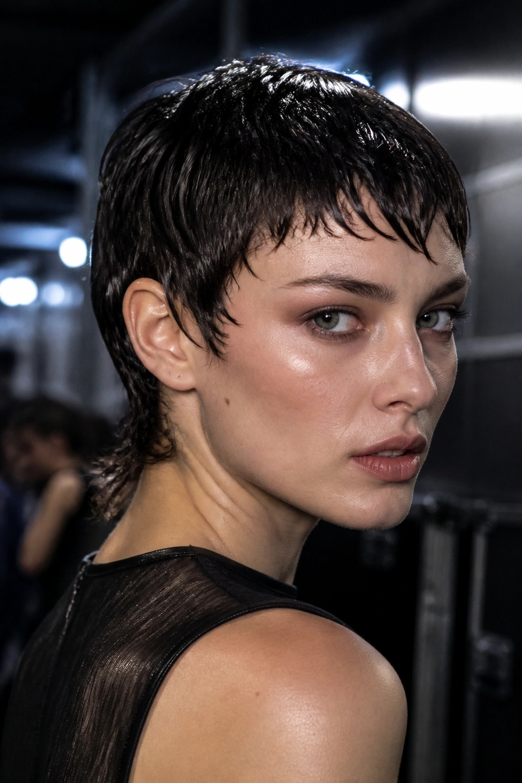 Close-up portrait of a real person with Wet-Look Pixie Mullet featuring glossy, sculpted shine.