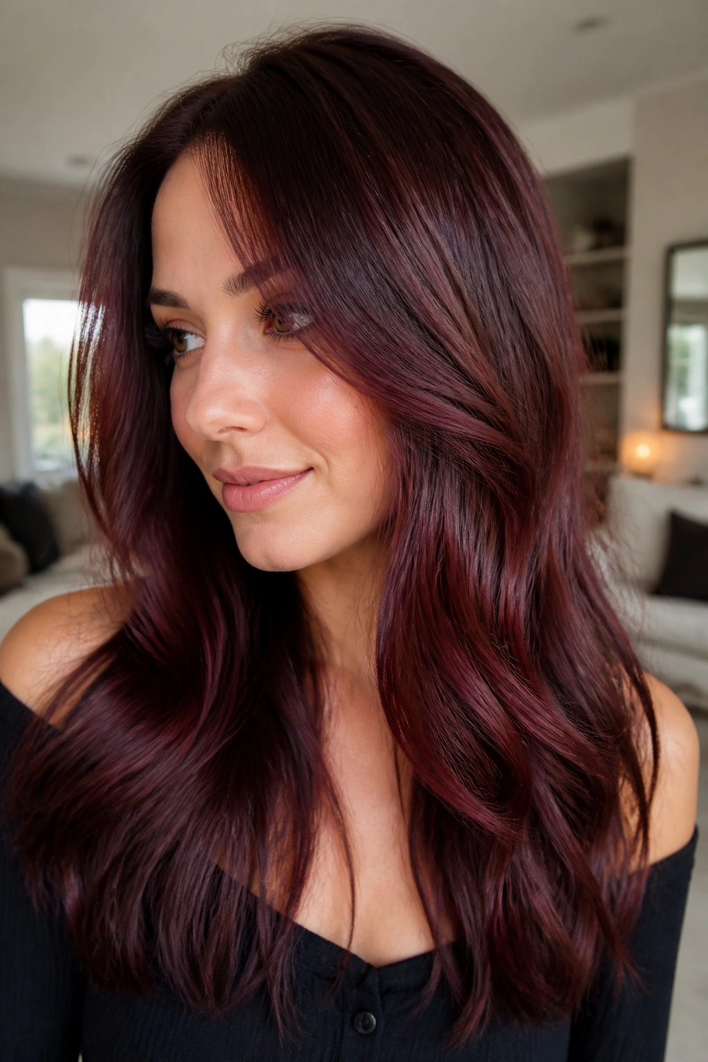 Close-up of a woman with deep brunette hair featuring wine-red reflections