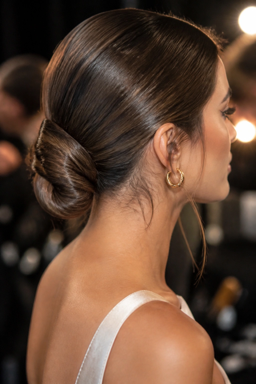 Close-up of wrapped-base twist bun on a real woman with hidden elastic