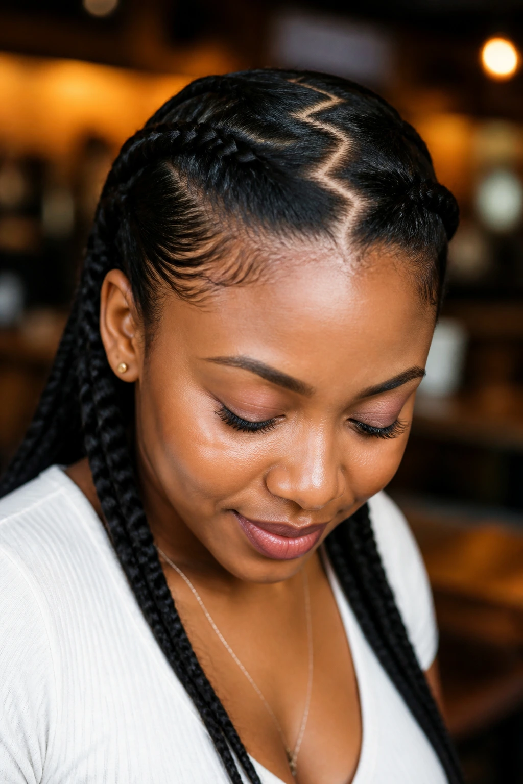 Close-up portrait of a real woman with zig-zag parted braids in natural light