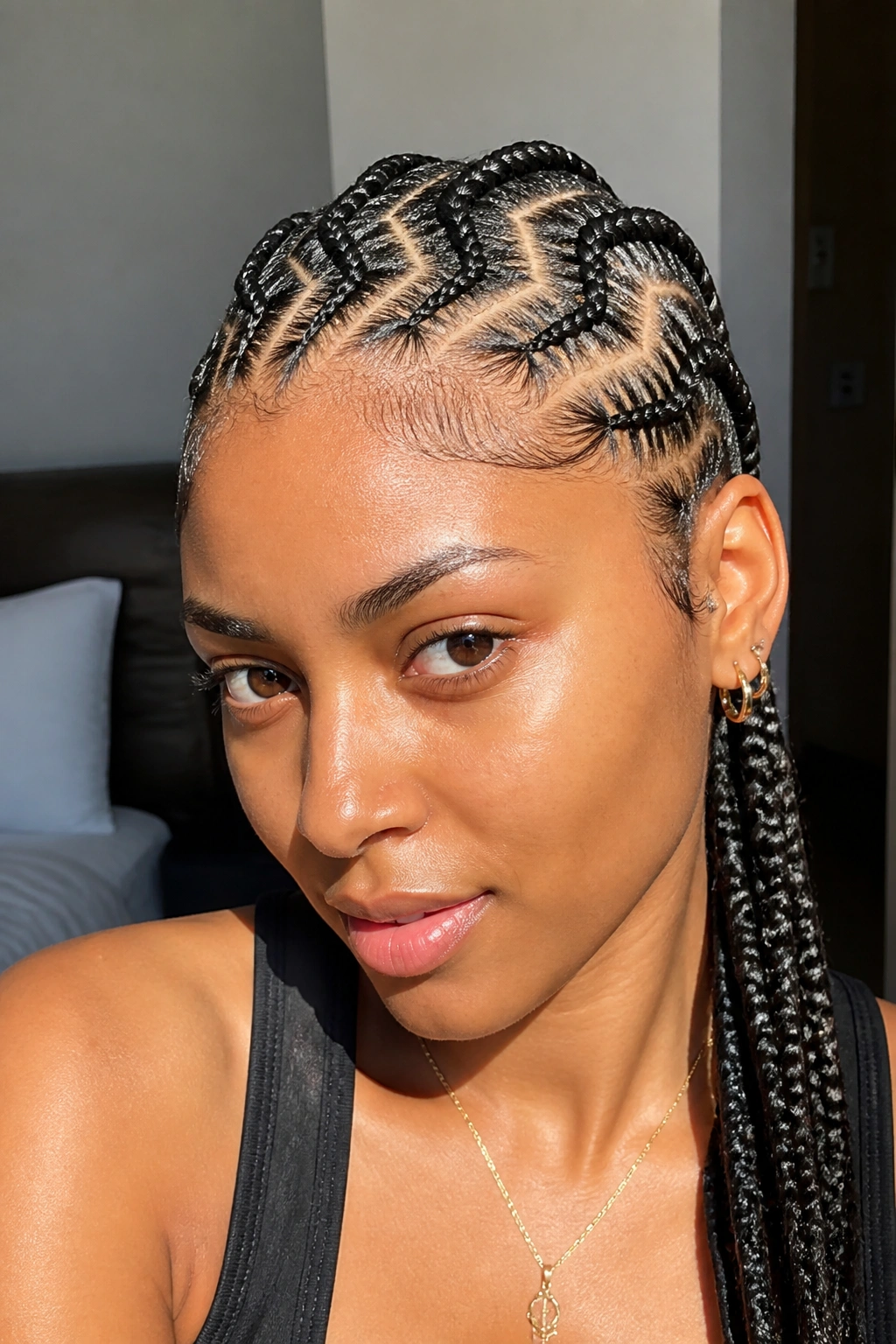 Real woman with zigzag-part cornrows showing bold scalp pattern