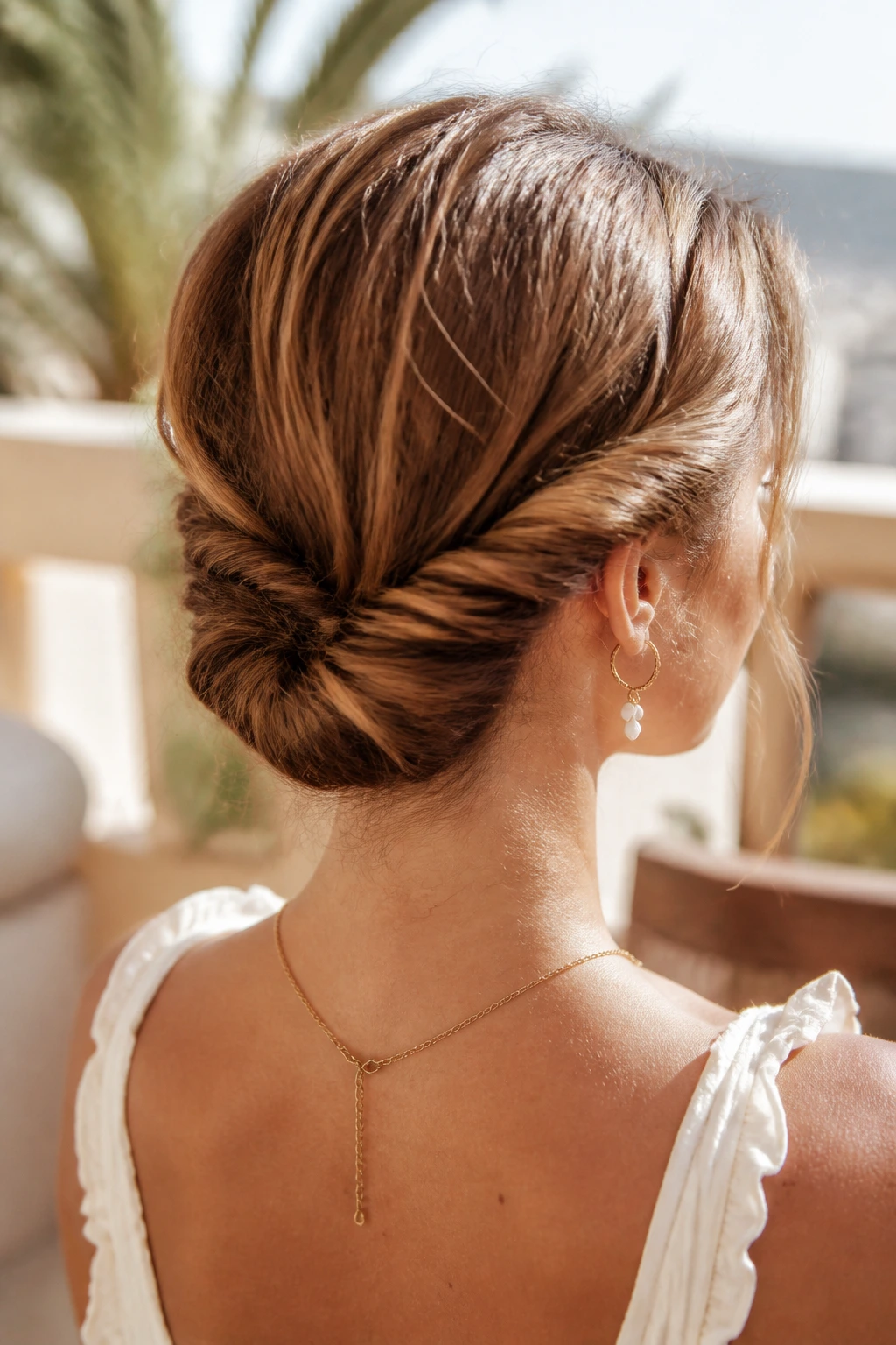 Close-up of a real woman with two twists forming a bohemian tuck at the back