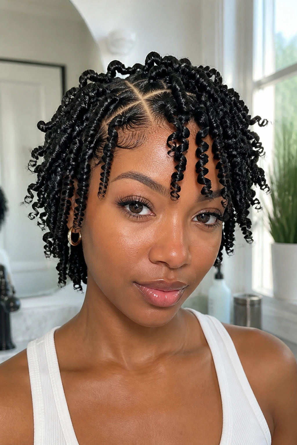 Close-up of a real person with finger coils and clean partings under daylight