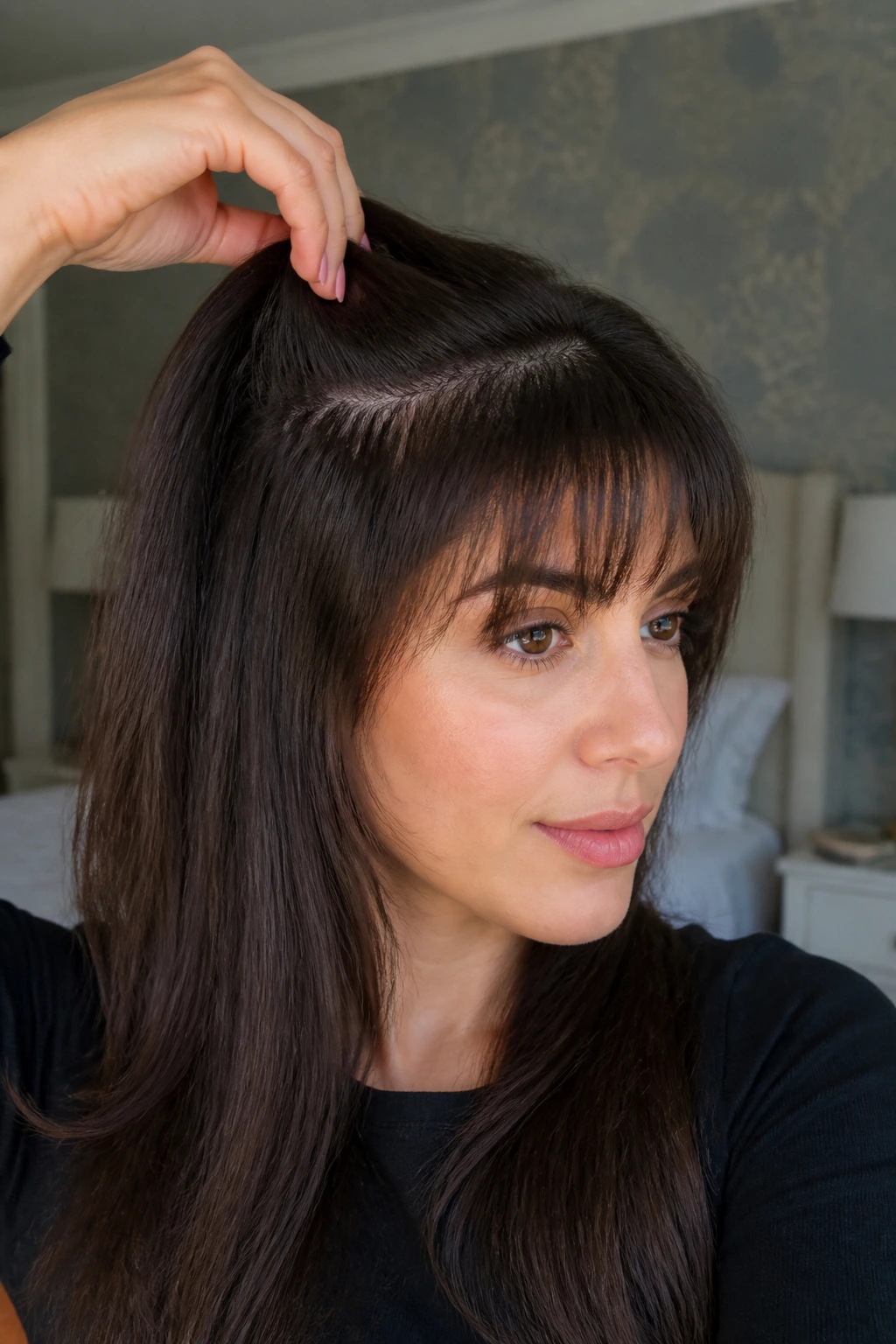 Close-up of a real person showing invisible internal bangs with top layer lifted and thinning underneath