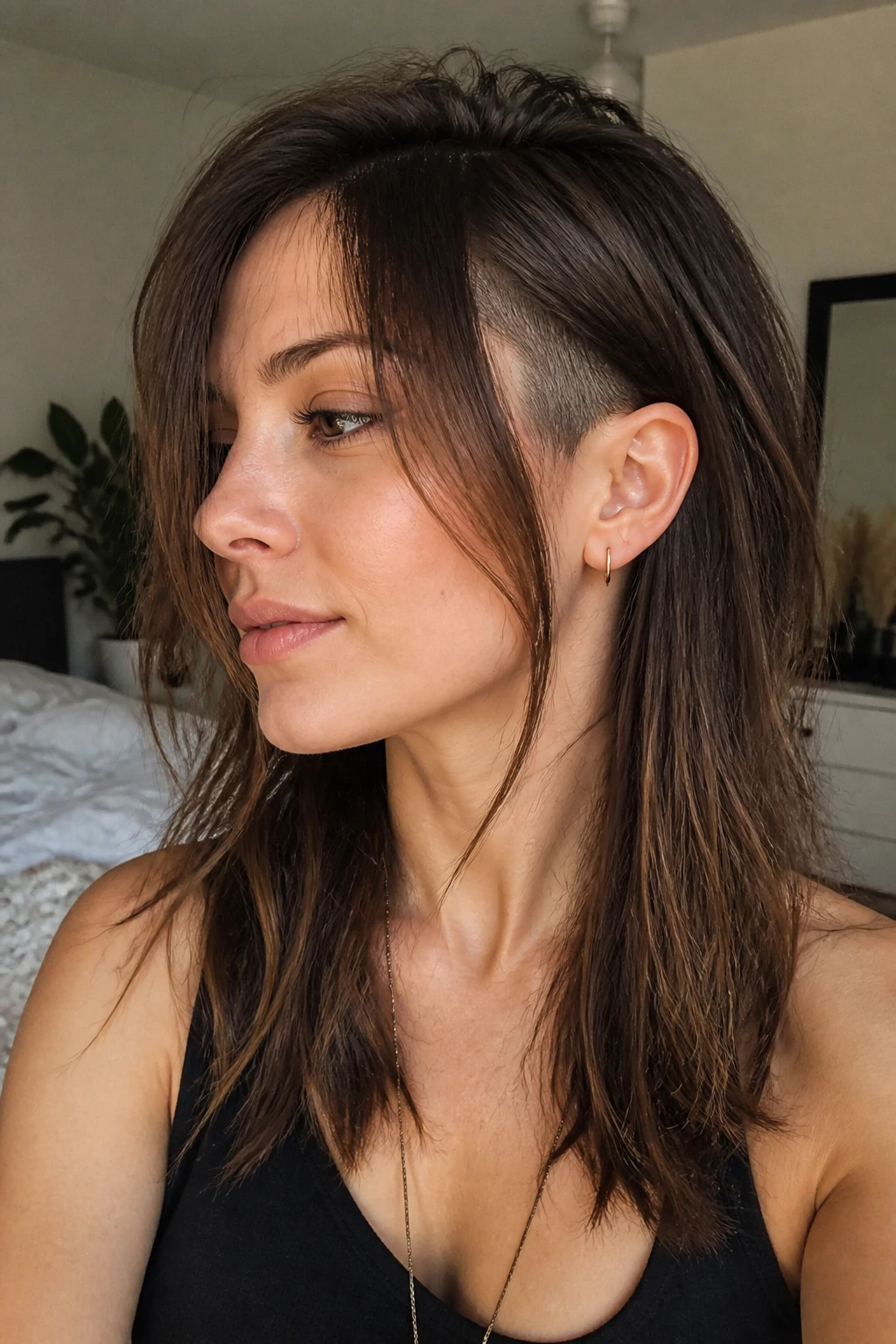 Close-up portrait of a real person with long face-framing layers and inner undercut