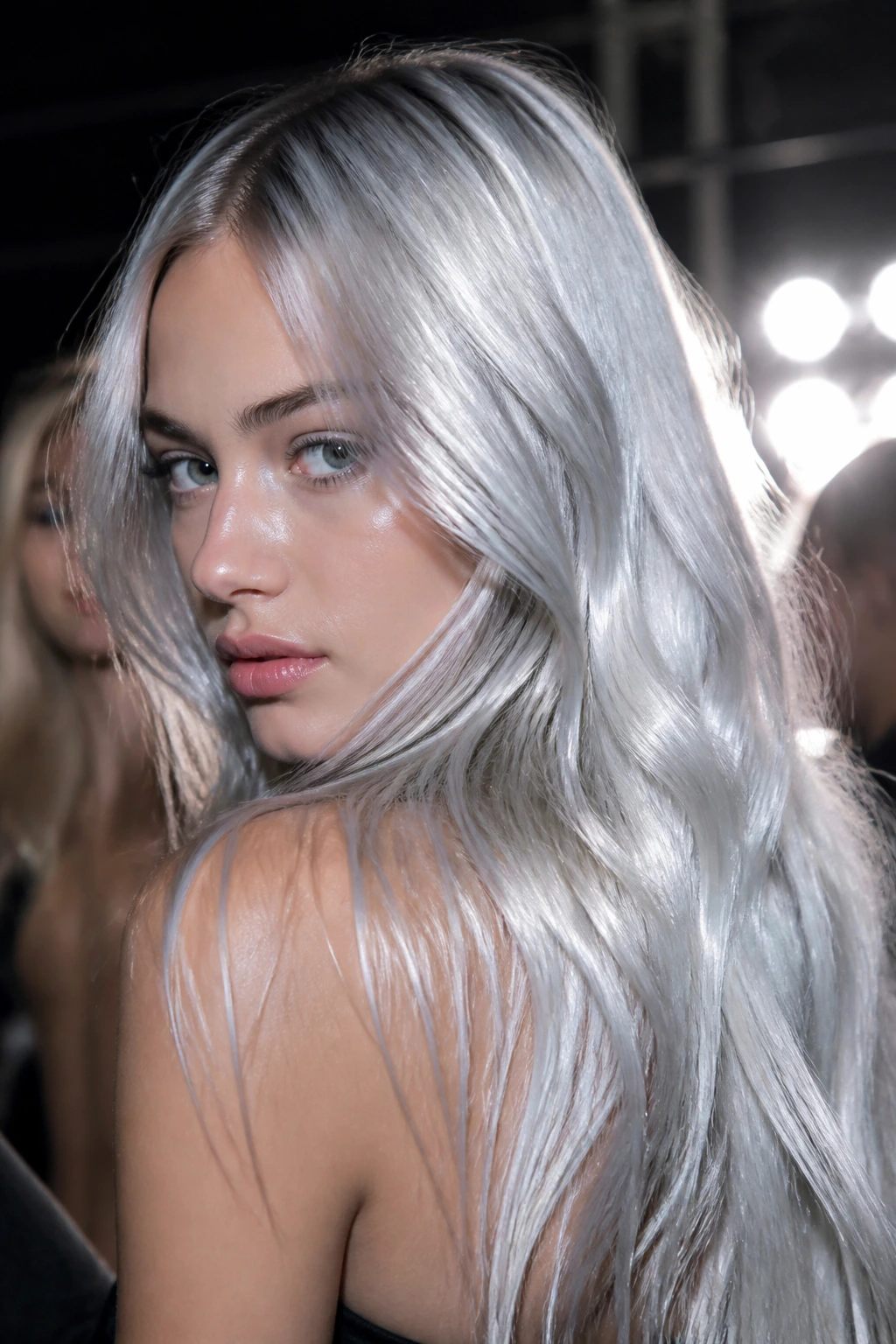 Real person with high-shine silver tinsel-inspired hair under stage lights